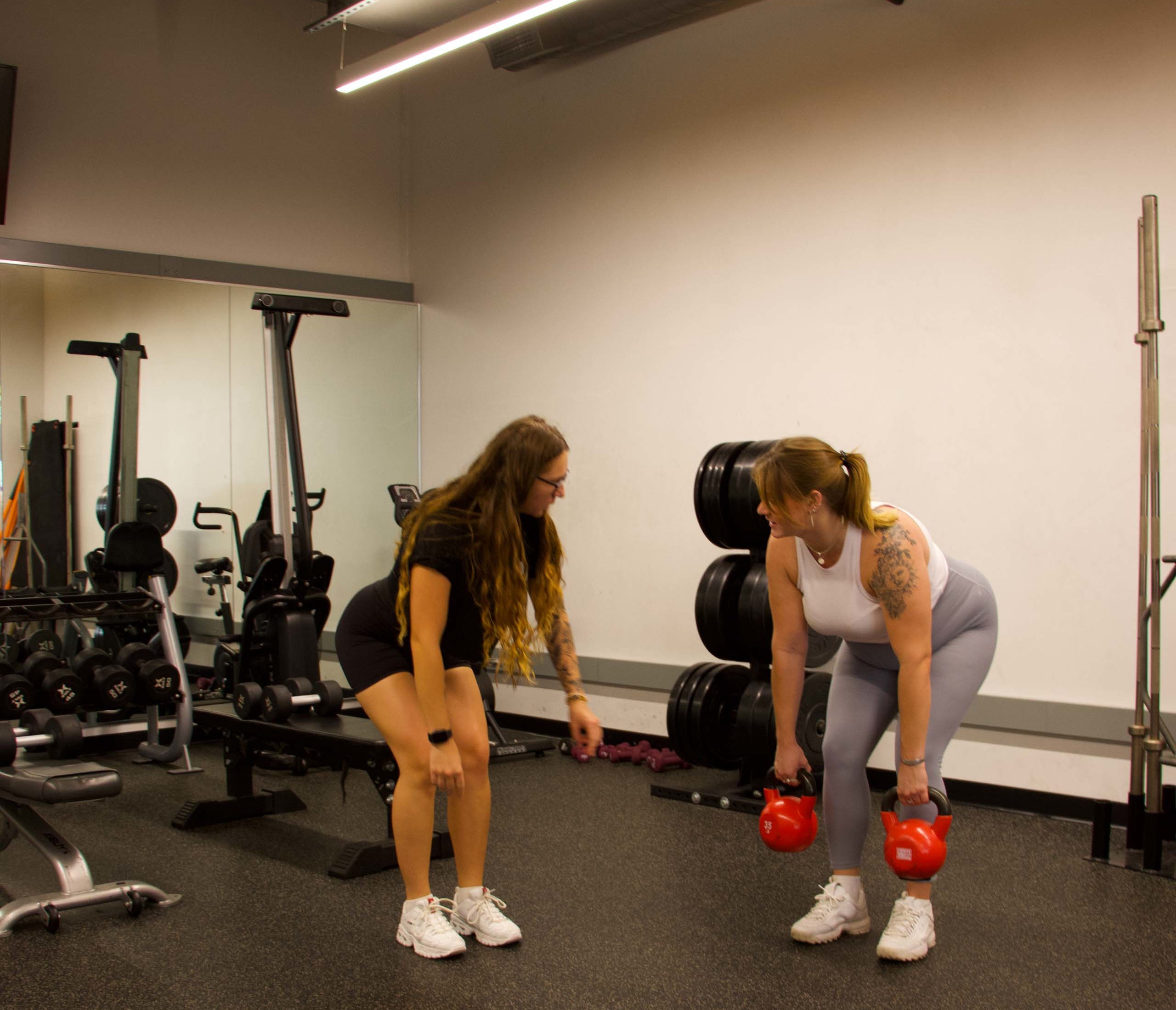 Two women working out on the functional fitness floor.
