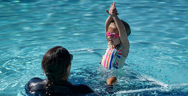 A child learning to swim.